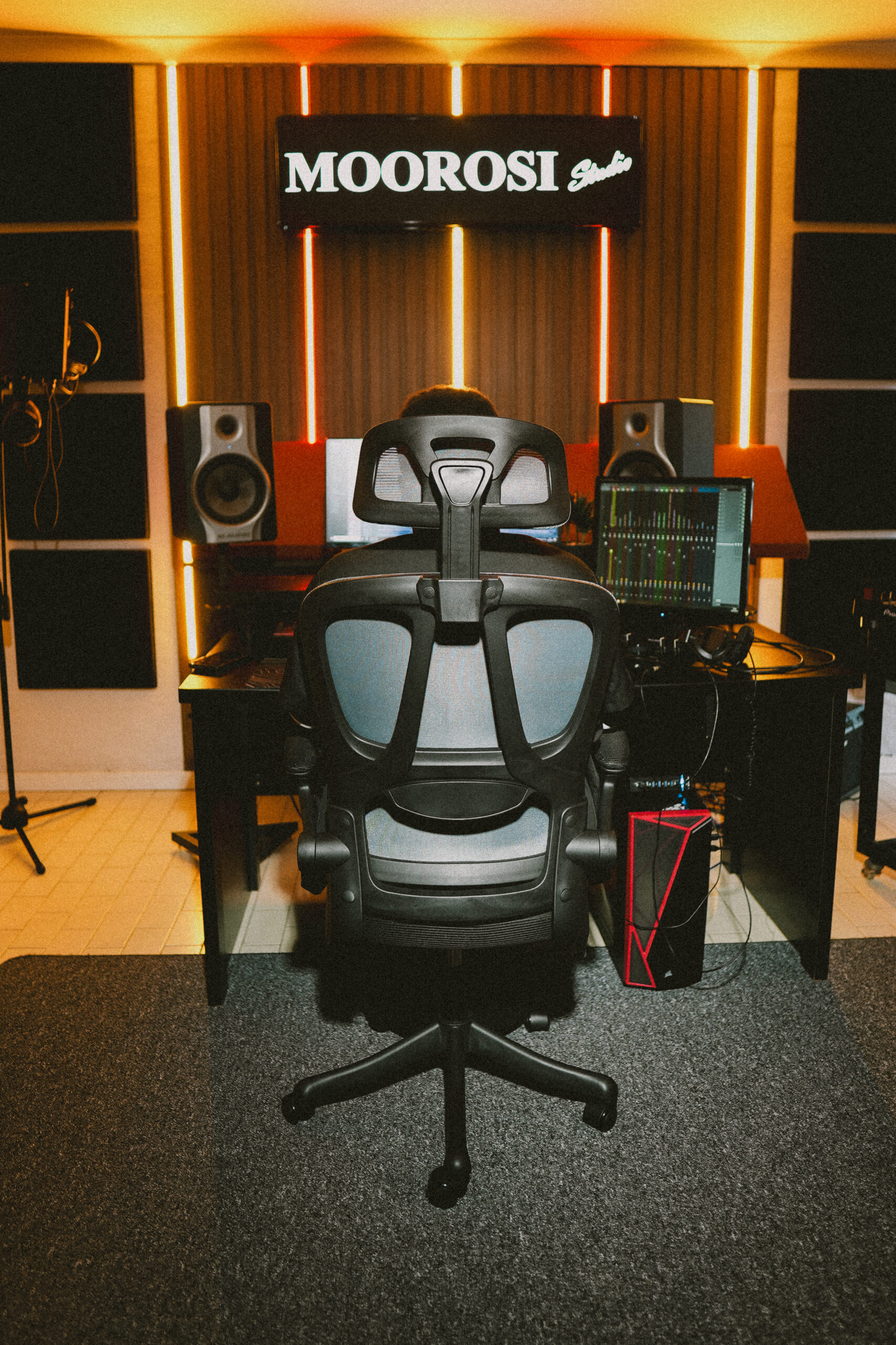 Students and friends gathered around the studio monitors during an intimate listening session