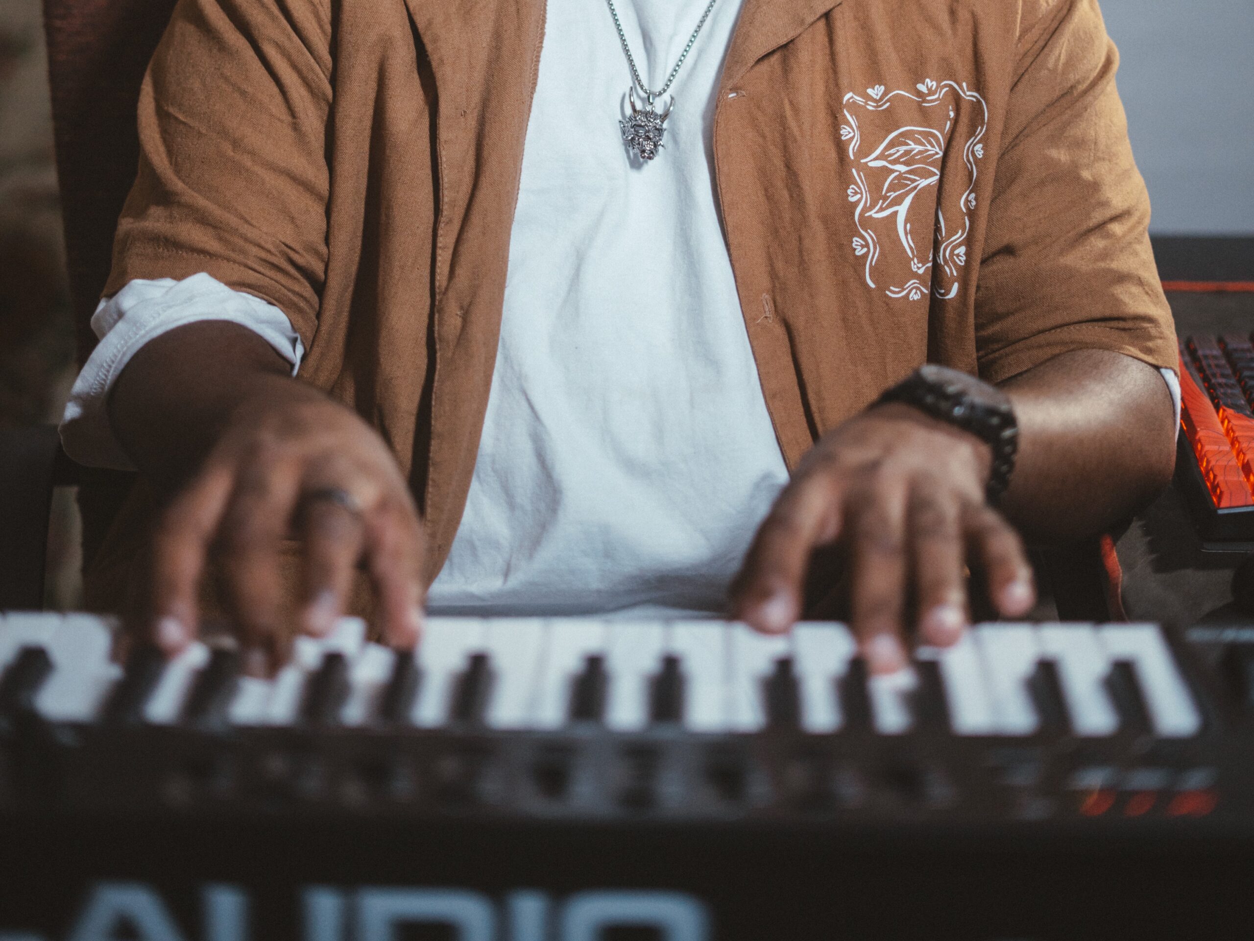 Student fine-tuning an audio mixer in front of acoustic studio monitors in Durban