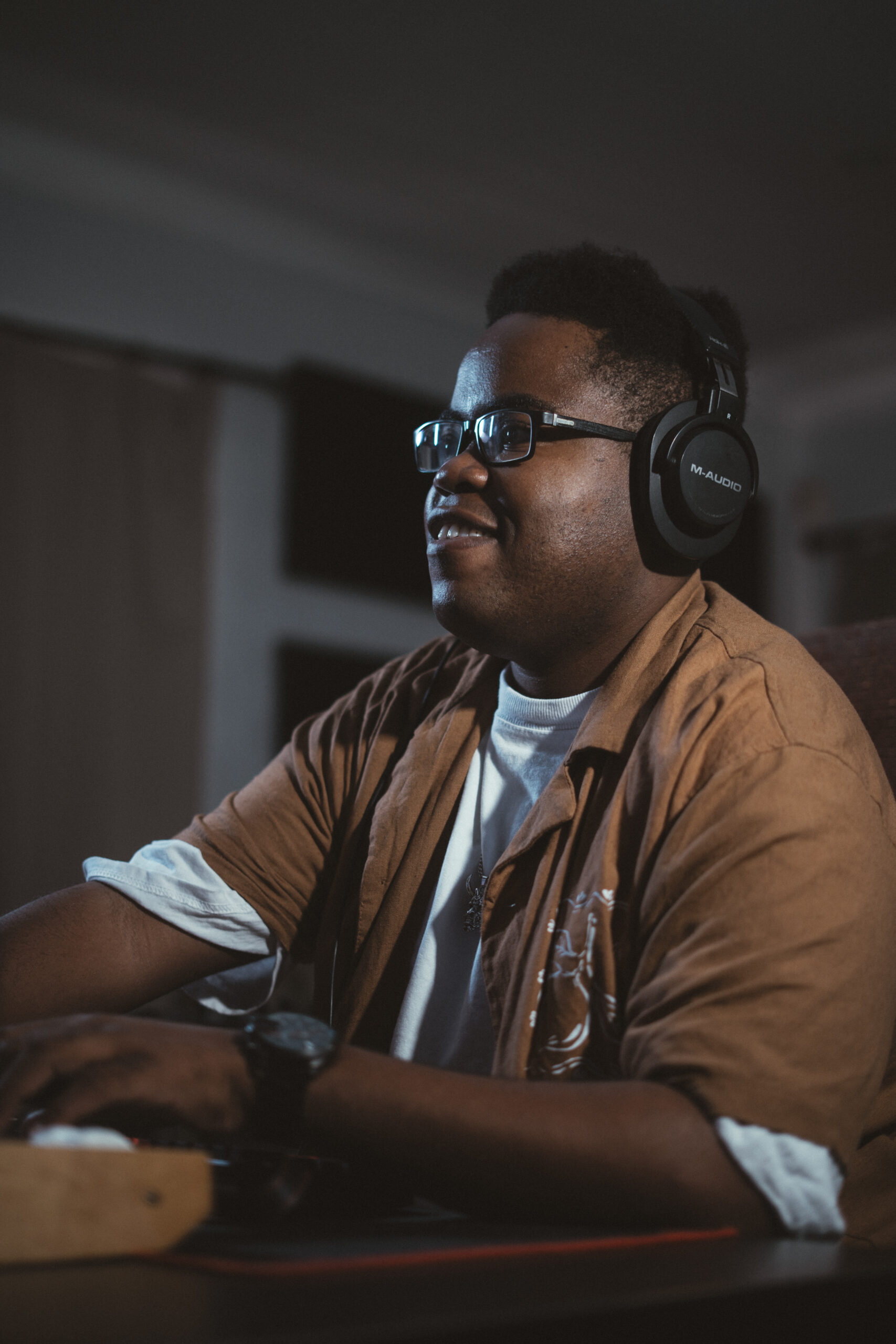 Adjusting synthesizer parameters and vocal tracks in front of studio monitors